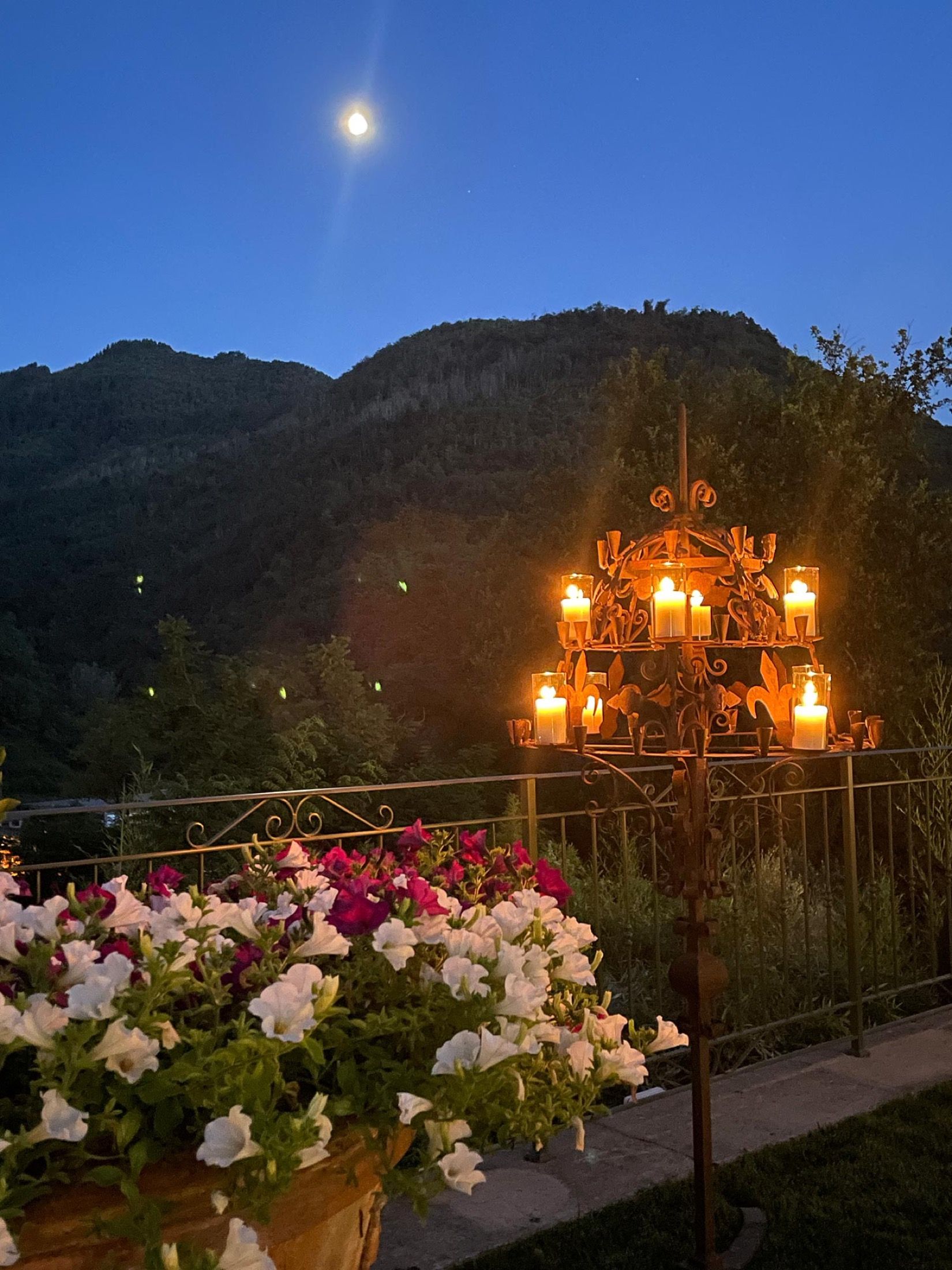 Candelabra and flowers on the terrace at dusk