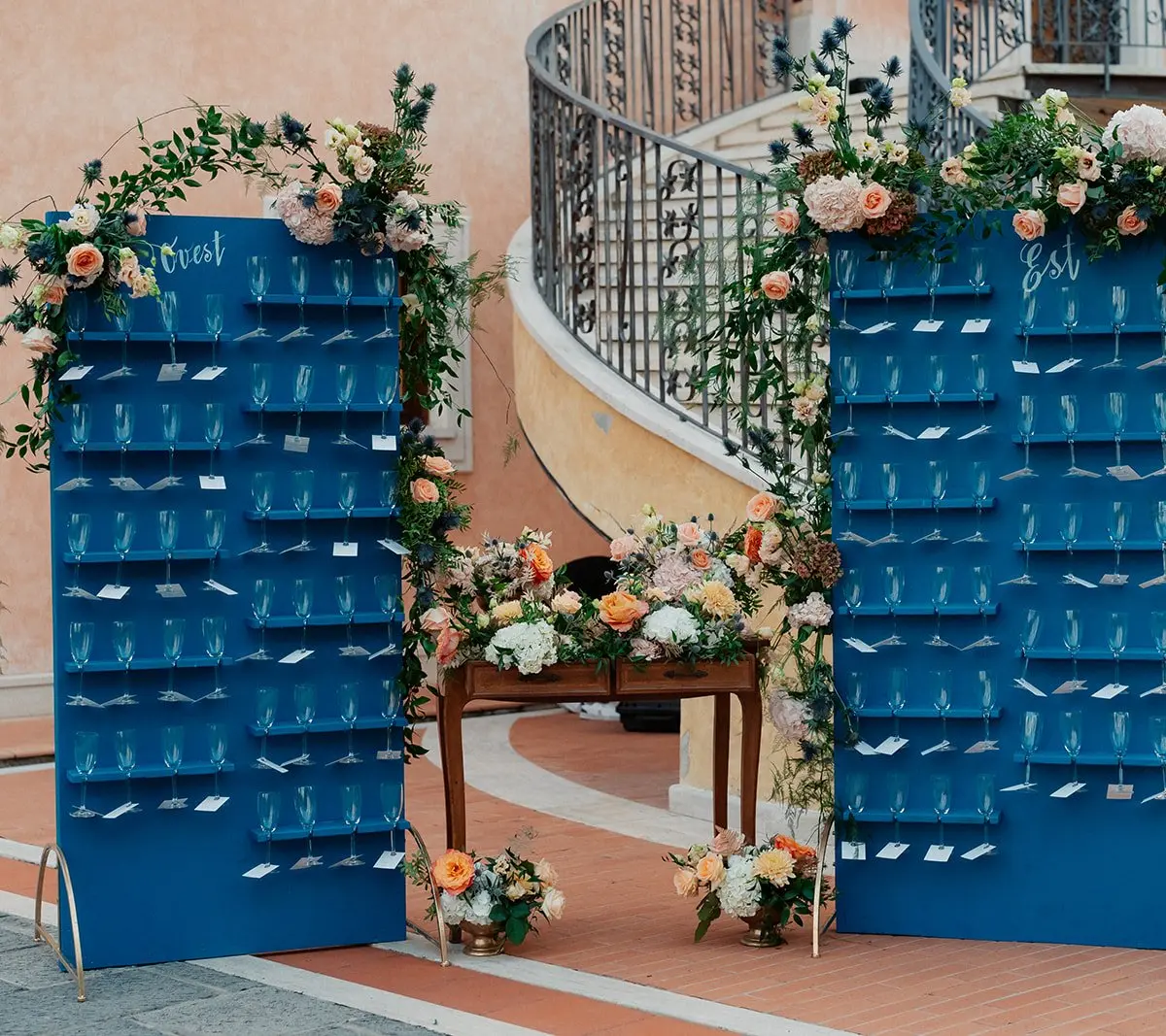 A blue champagne wall dressed with peach florals at Villa Valentini Bonaparte