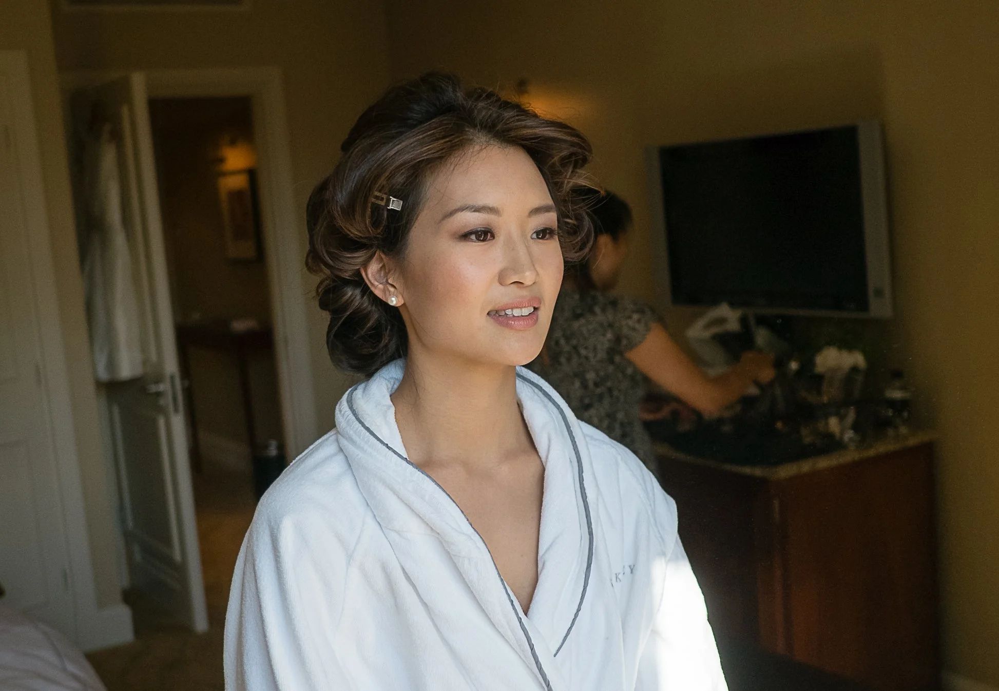 A bride in a white robe with curlers in, getting ready, The Berkeley