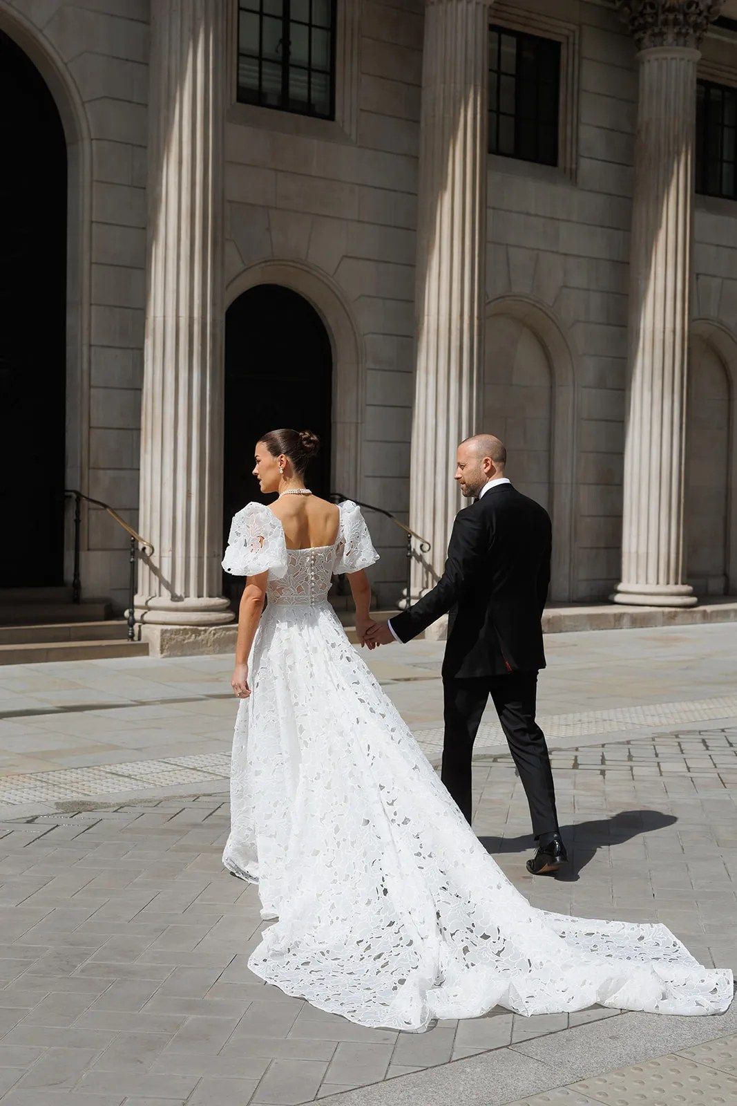 Emily and John, hand in hand beneath the colonnade, The Ned