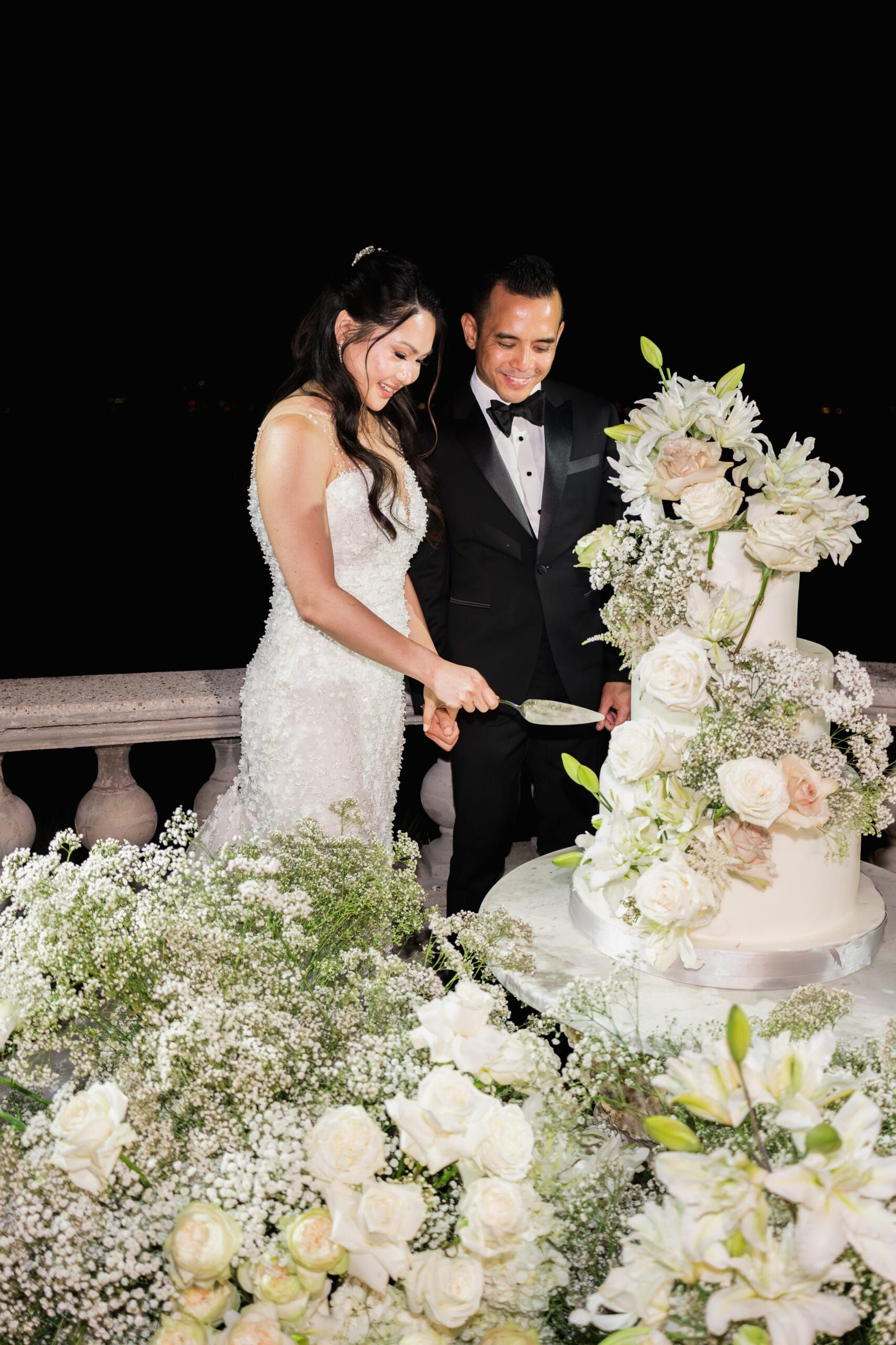Cutting the cake on a balustrade above the sea