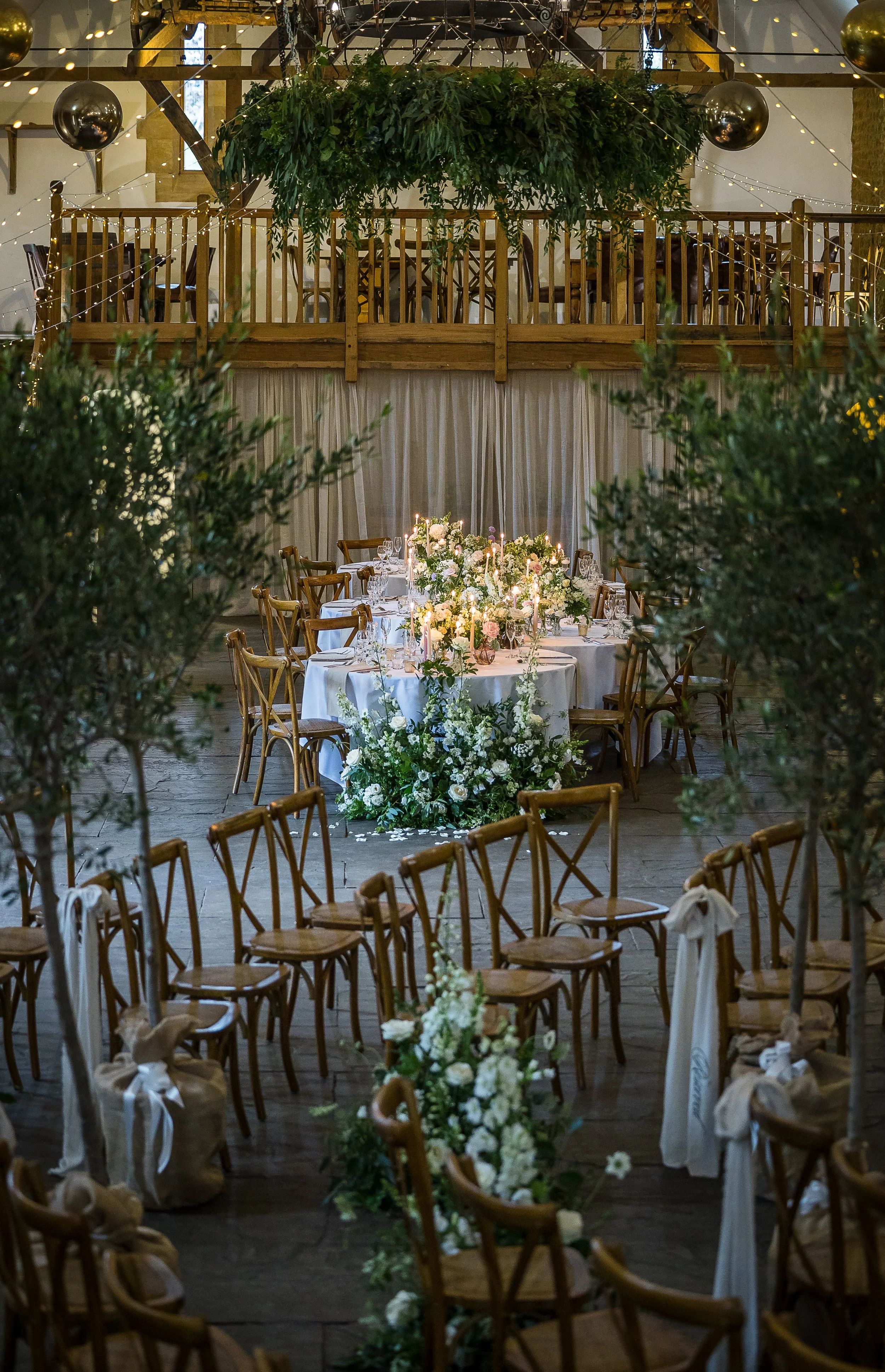 The Tithe Barn dressed for a ceremony, foliage above the balcony, Haselbury Mill, Crewkerne, England