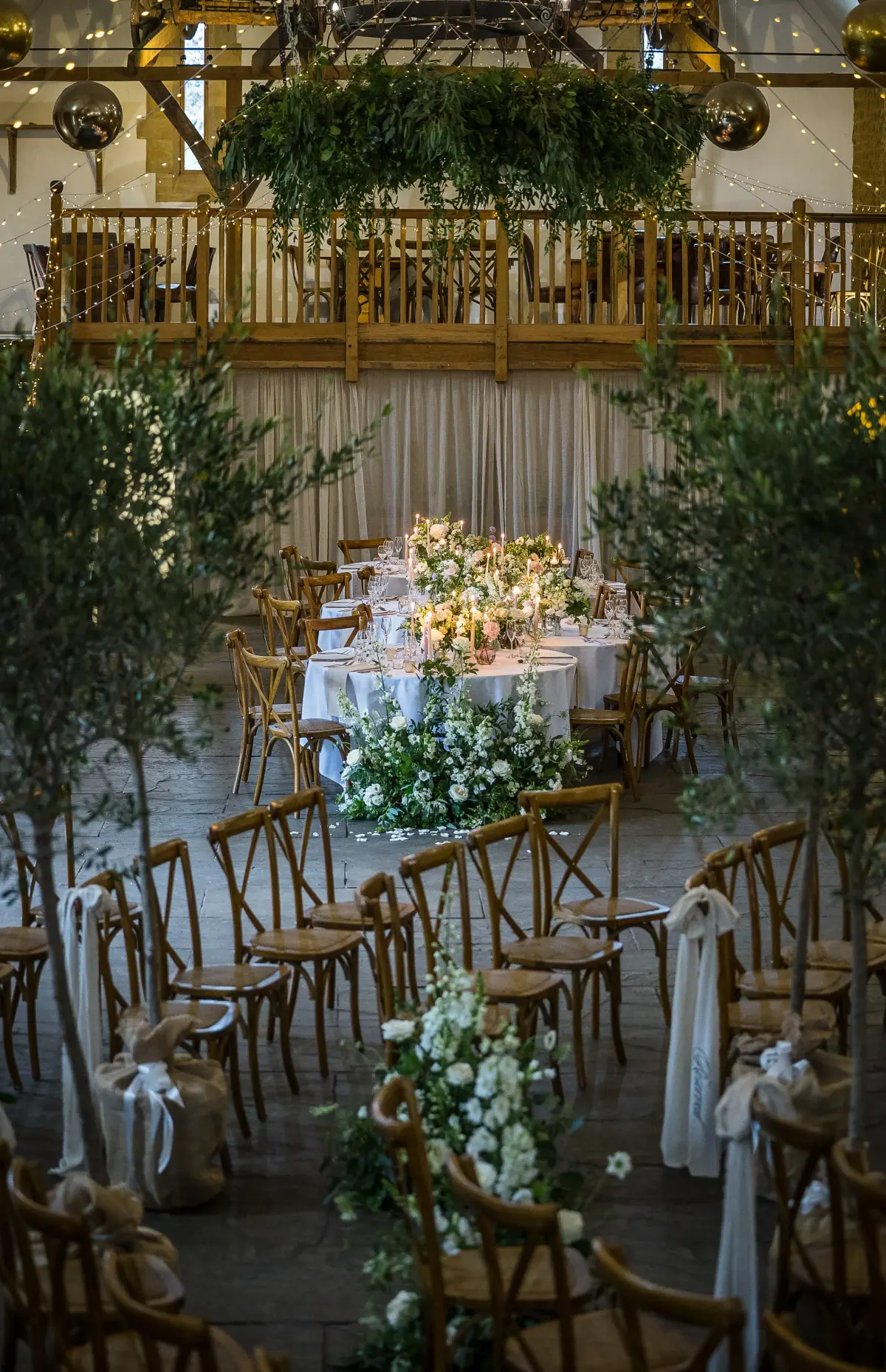The Tithe Barn dressed for a ceremony, foliage above the balcony, Haselbury Mill, Crewkerne, England