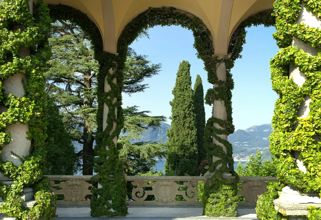 The ivy-clad Loggia Durini with its arches framing cypress and the lake, Villa del Balbianello
