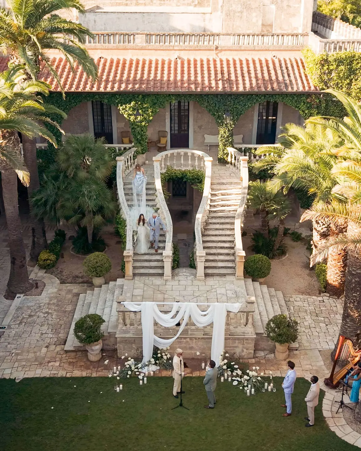 From above: the bride coming down the double staircase into the courtyard
