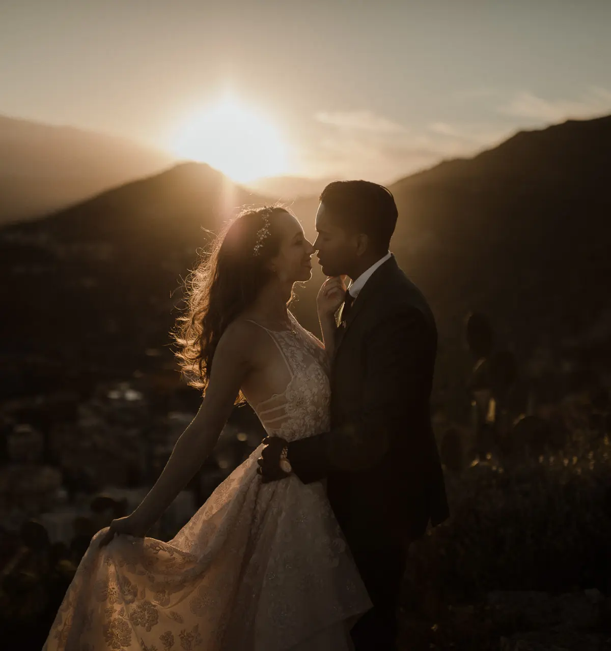 The couple at sunset, Etna and its snow behind them, the town below