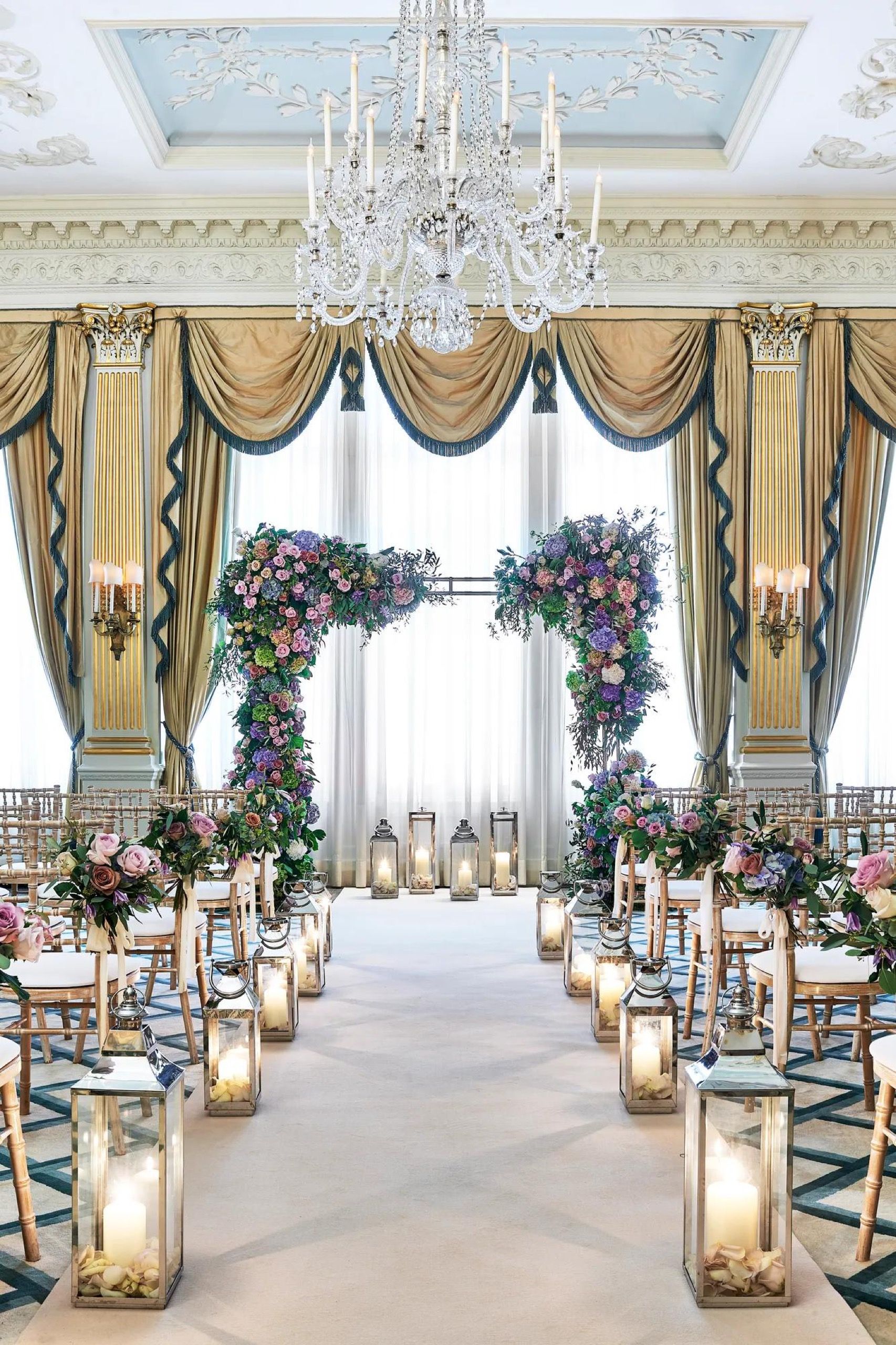 A candlelit ceremony aisle in the Drawing Room at Claridge's