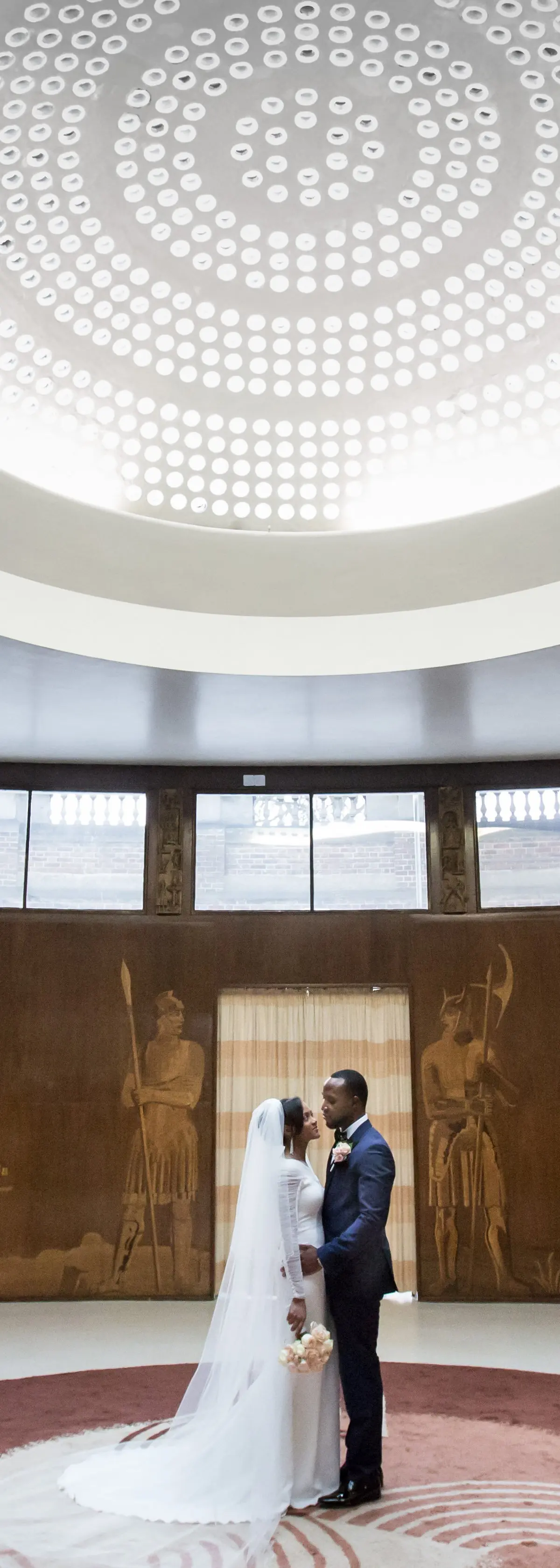 A couple beneath the glass dome of the Art Deco Entrance Hall