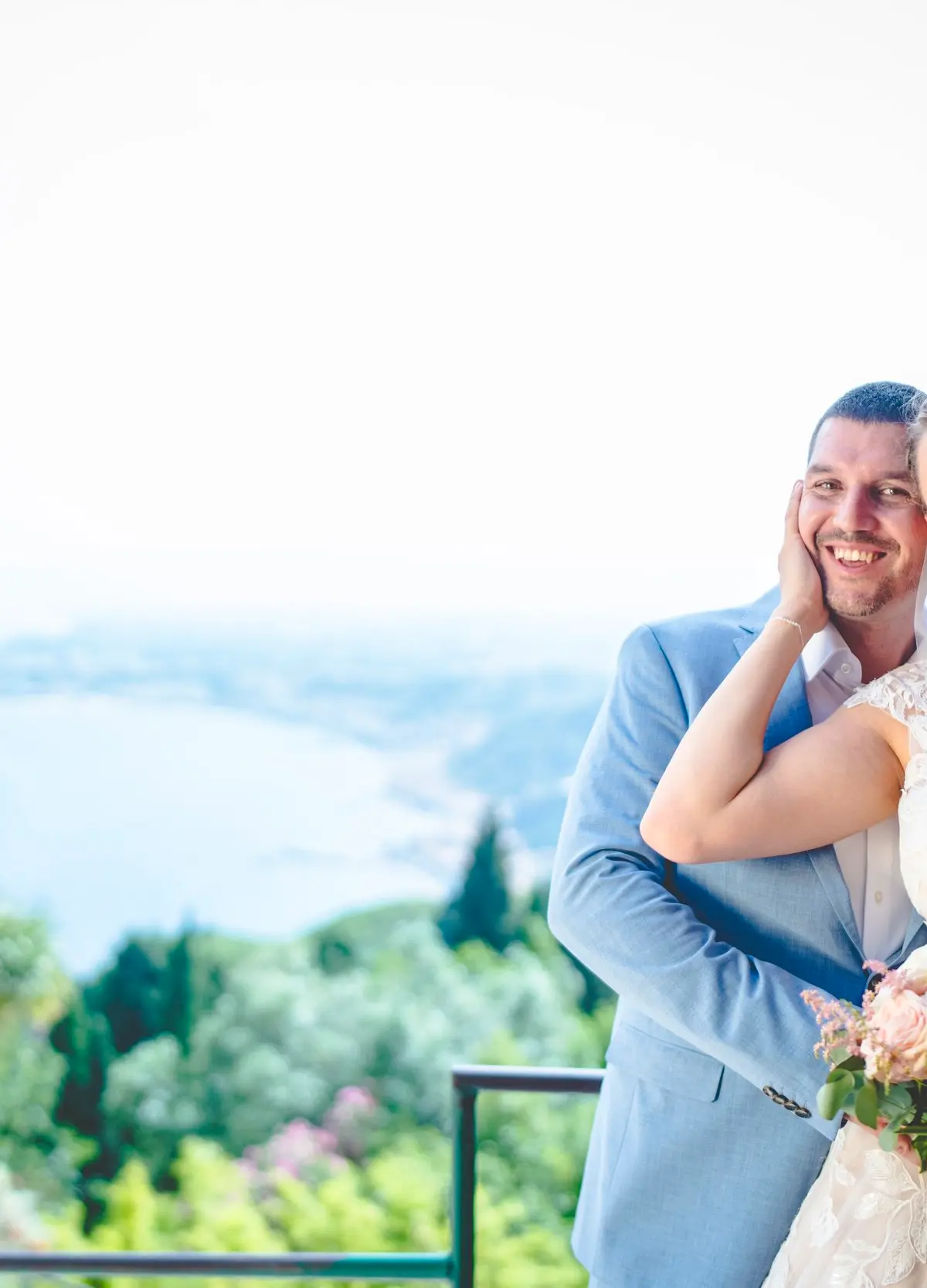 The couple on a terrace above the bay, the coast running north behind them