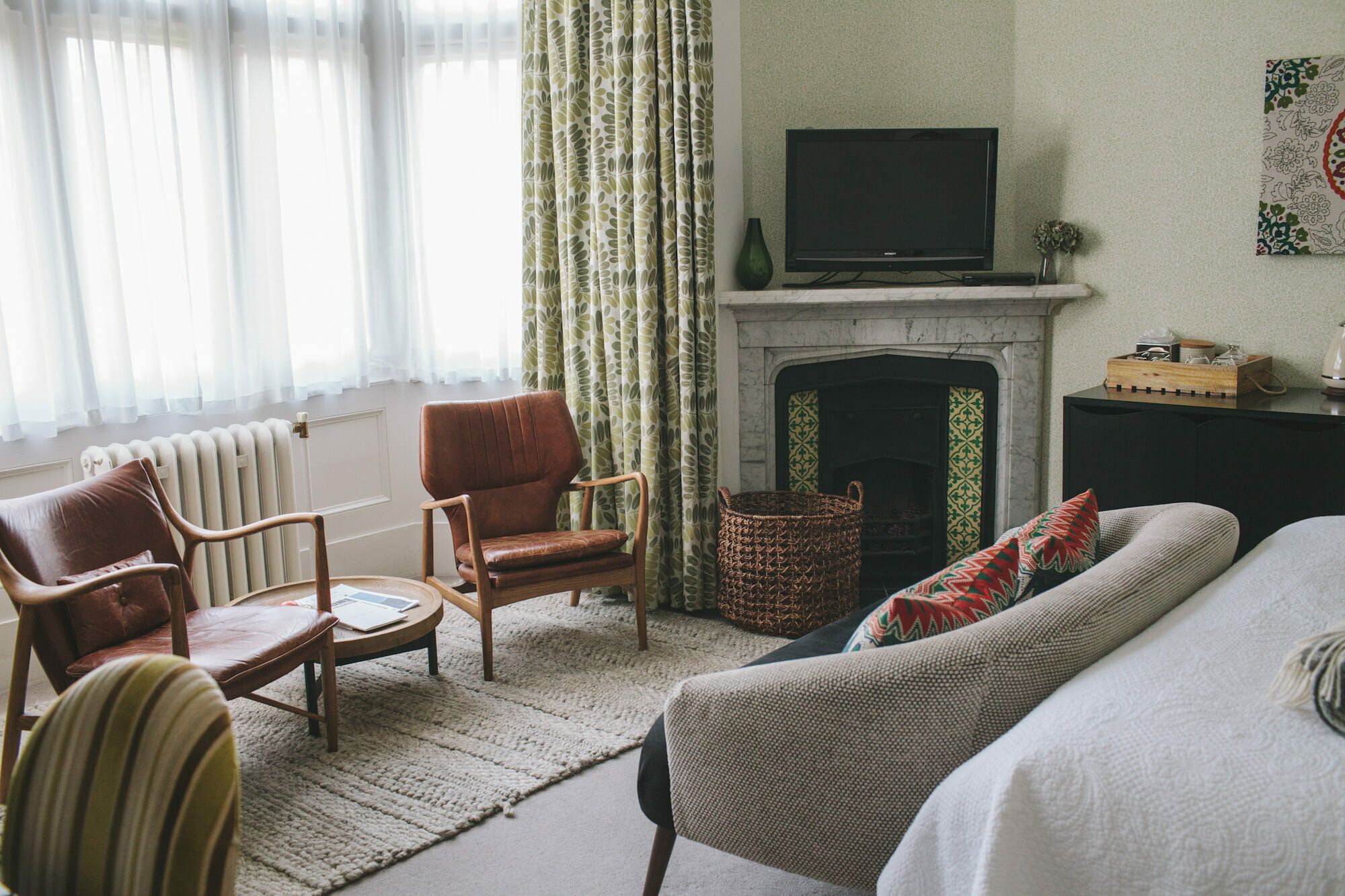A suite sitting room with sofas and armchairs for gathering