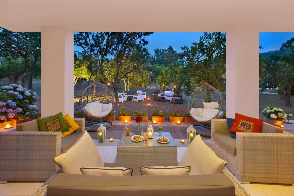 Wedding tables set beneath the centuries-old citrus grove at Hotel Alpha