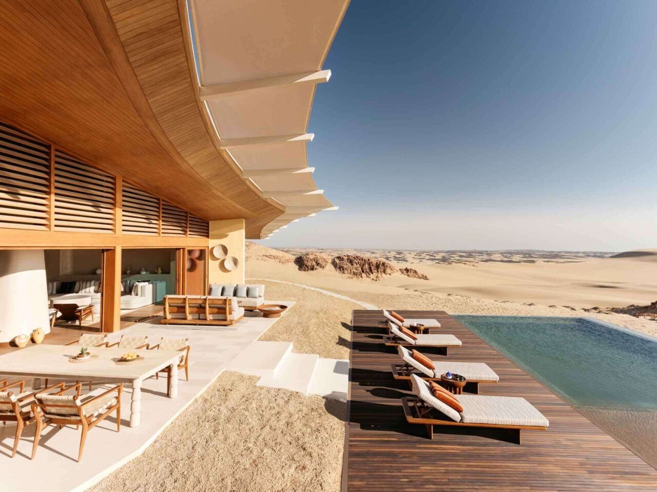 The sculptural timber architecture of Six Senses Southern Dunes, designed by Foster + Partners, above the desert of AlUla, Saudi Arabia