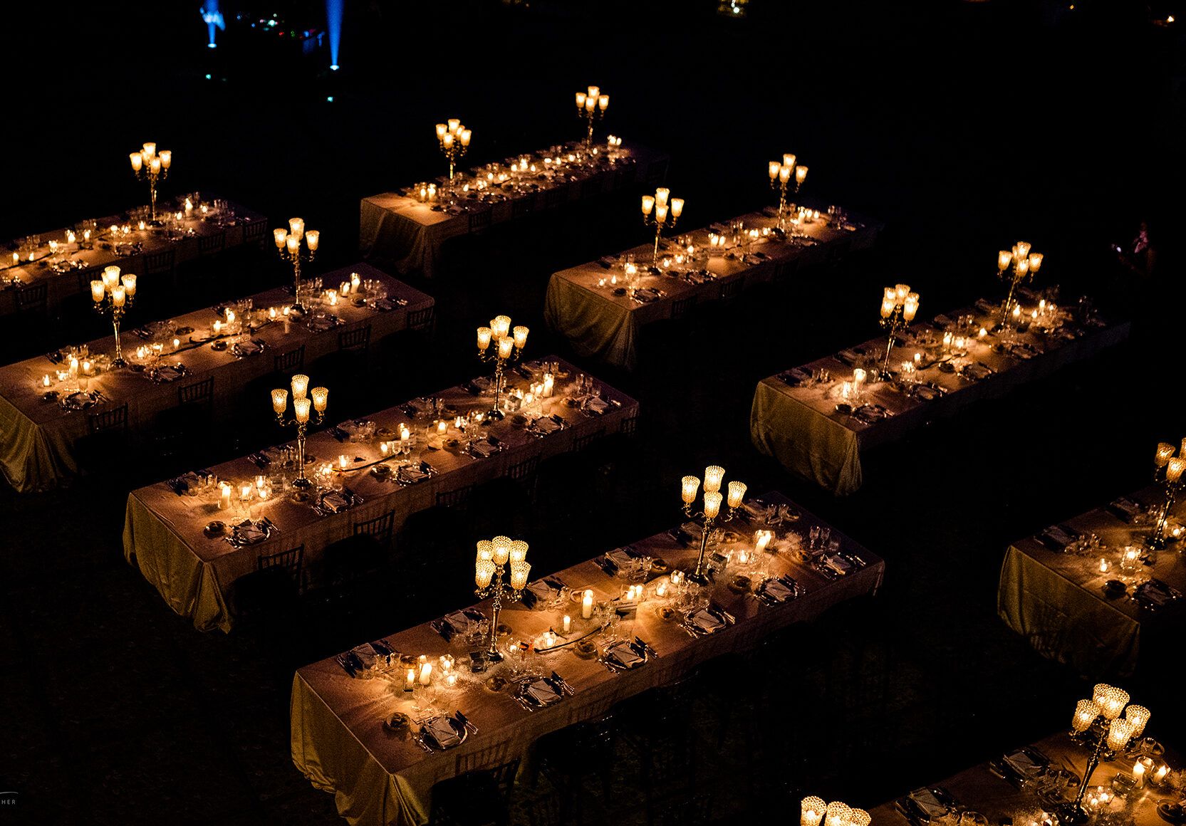 Aerial of the candlelit outdoor reception on the estate lawns at night