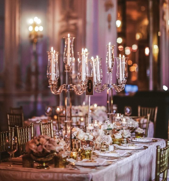 A candlelit table, gold accents