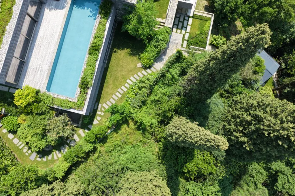 An aerial of the villa, its pool and terraces above Varenna