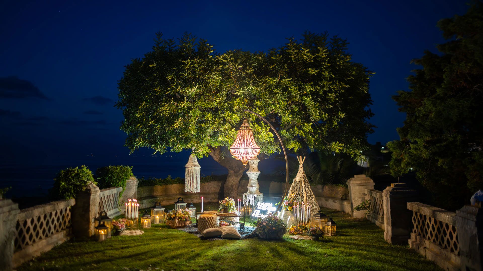 A wedding dinner on the garden terrace at dusk, Villa Paola, Tropea, Italy