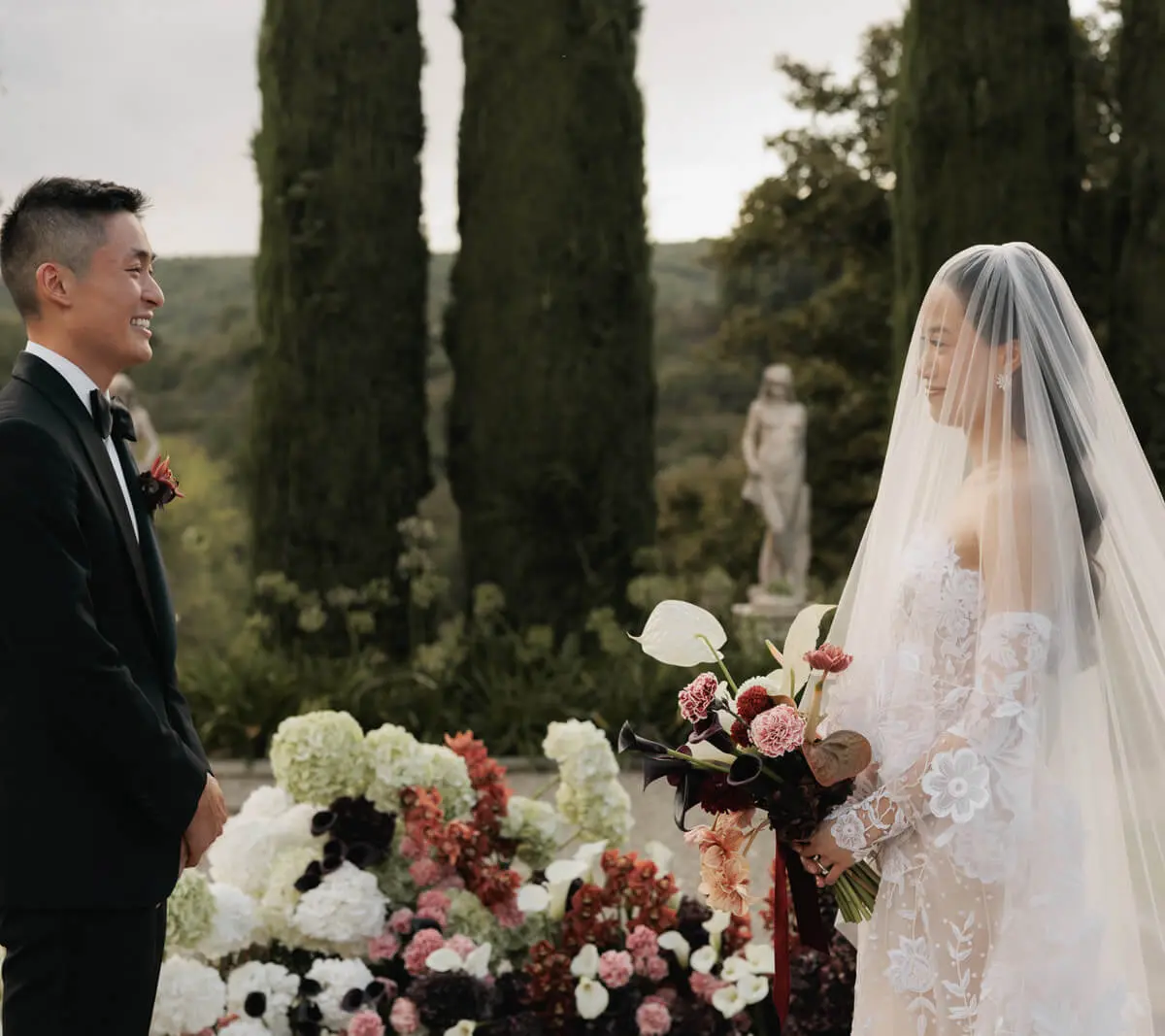 A wedding ceremony among cypress trees in a Tuscan garden