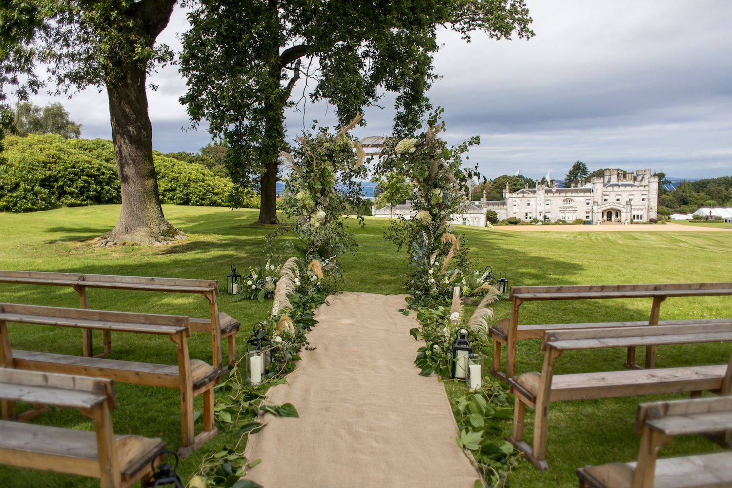 A flower-lined path across the lawn leading toward the castle
