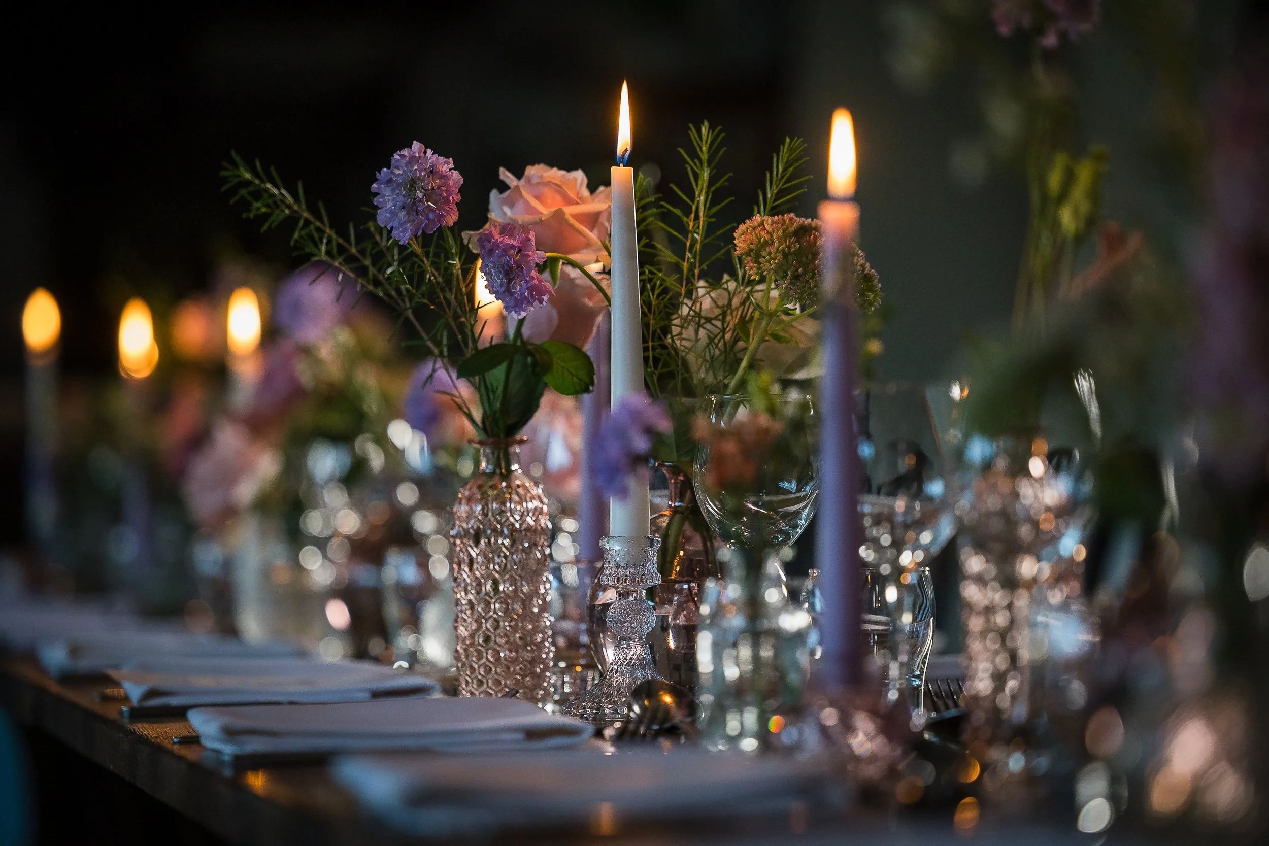 Candlelight and flowers along the wedding table