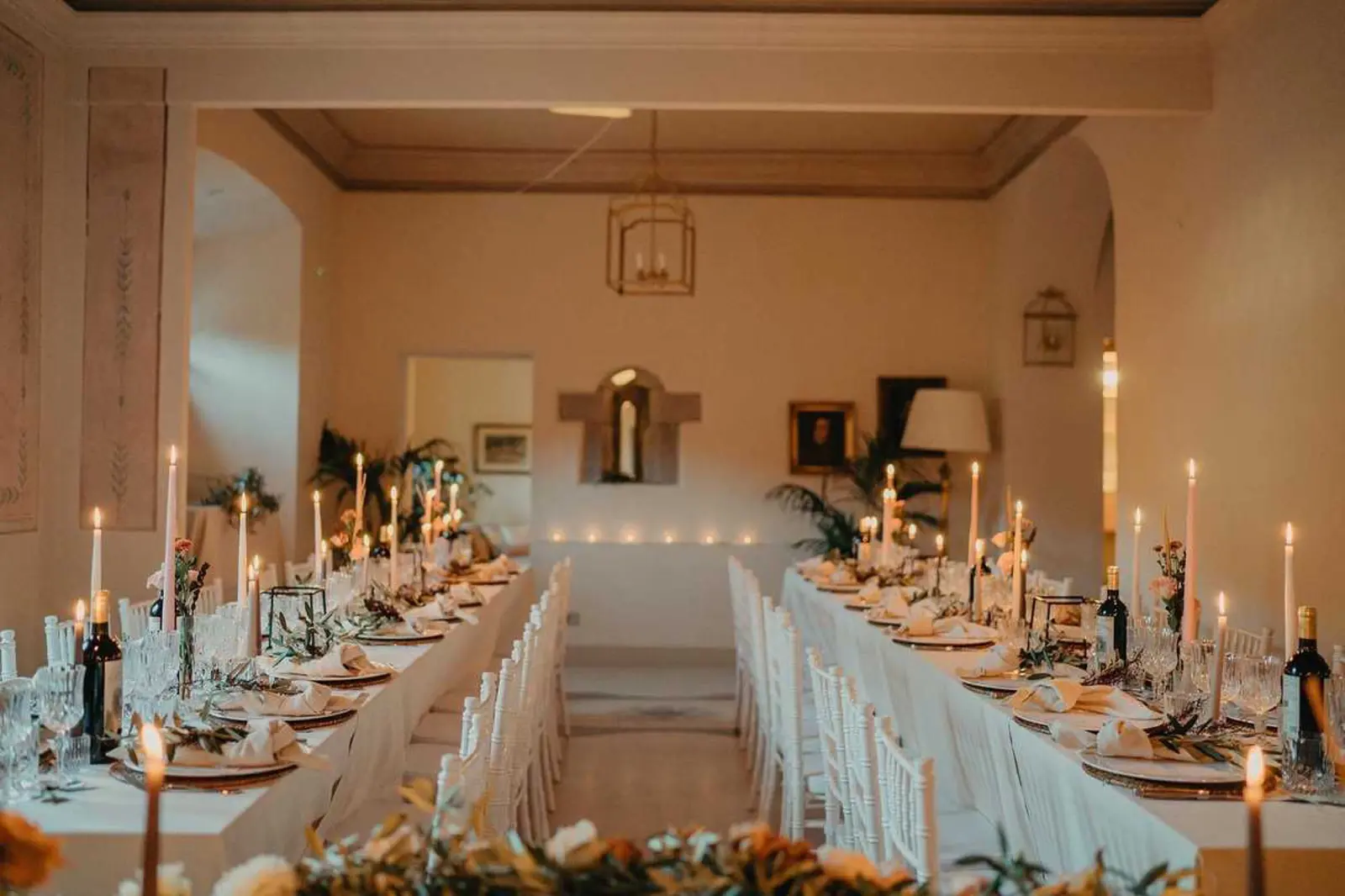 A frescoed salon set for a wedding dinner