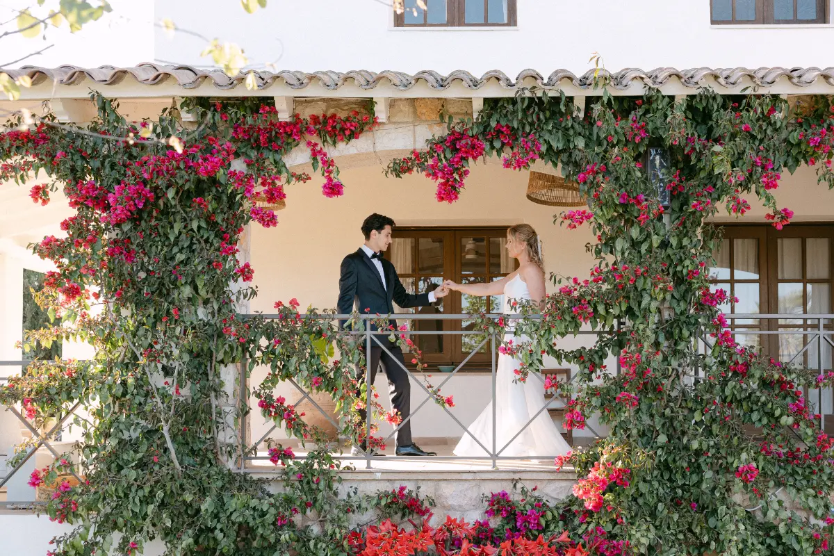 Couple on the bougainvillea-covered balcony