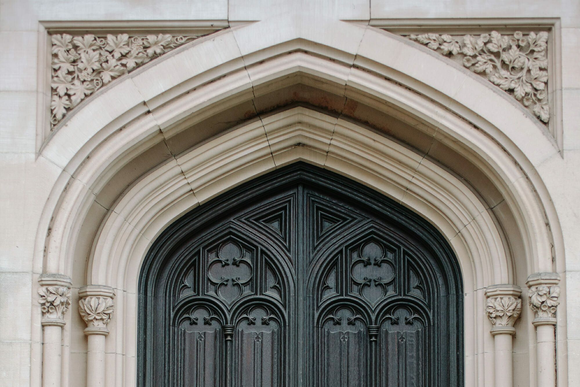 An ornate carved gothic-arched doorway on the estate