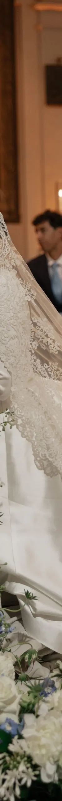The bride signs the register beside a cascading floral runner
