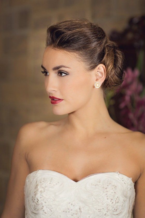A bridal portrait in profile, sleek low bun and a bold red lip