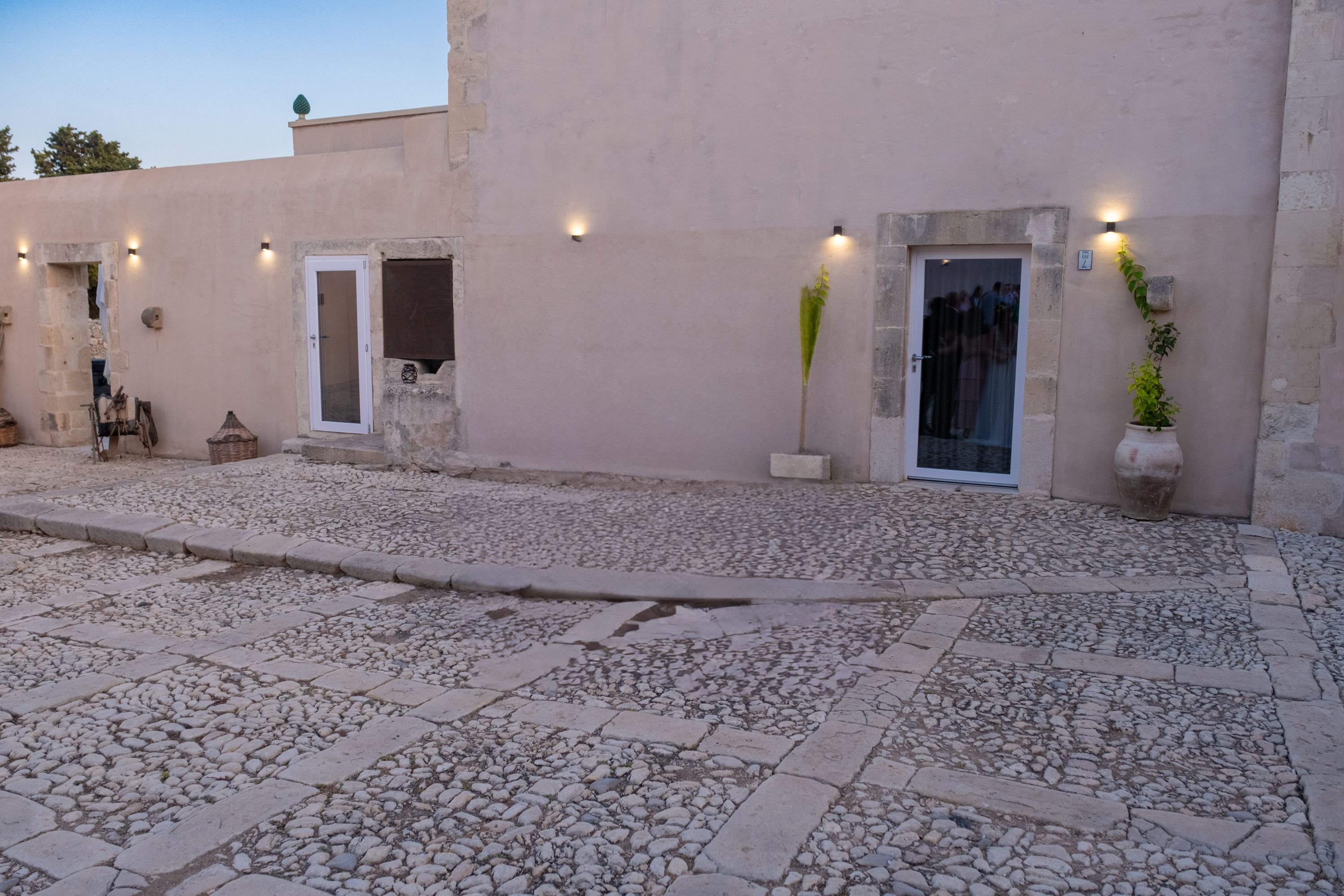 The estate's stone facade, agave and citrus at the door