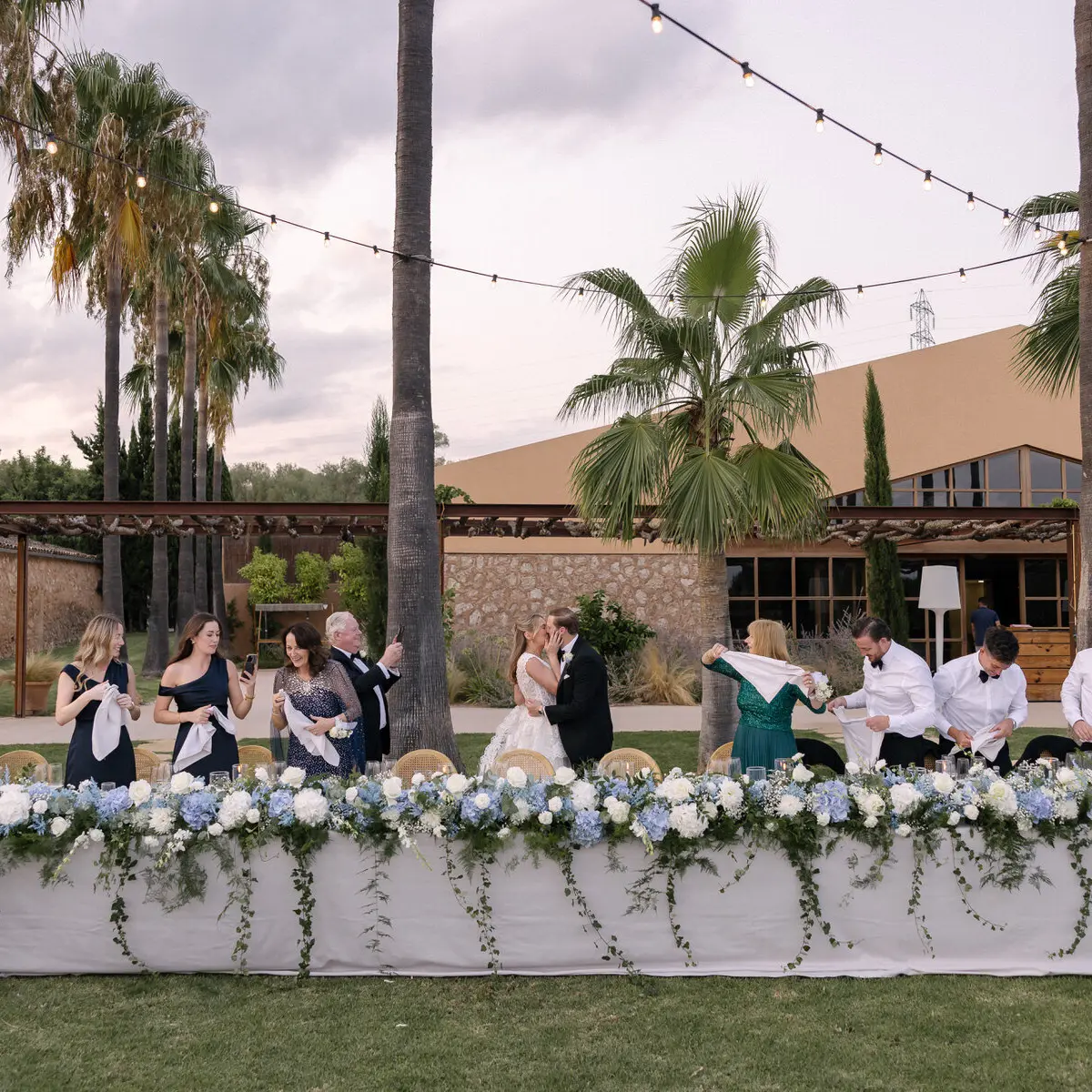 A long table set beneath the palms