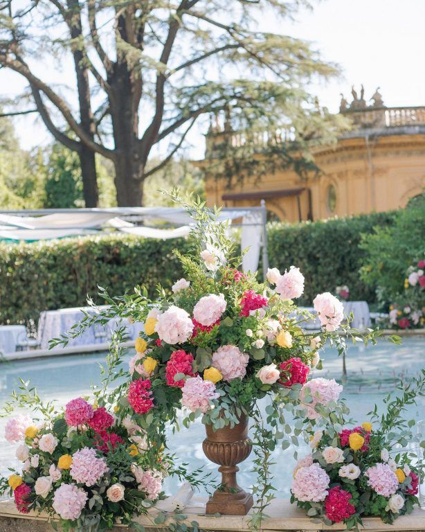 A colourful ceremony arrangement beside a villa pool