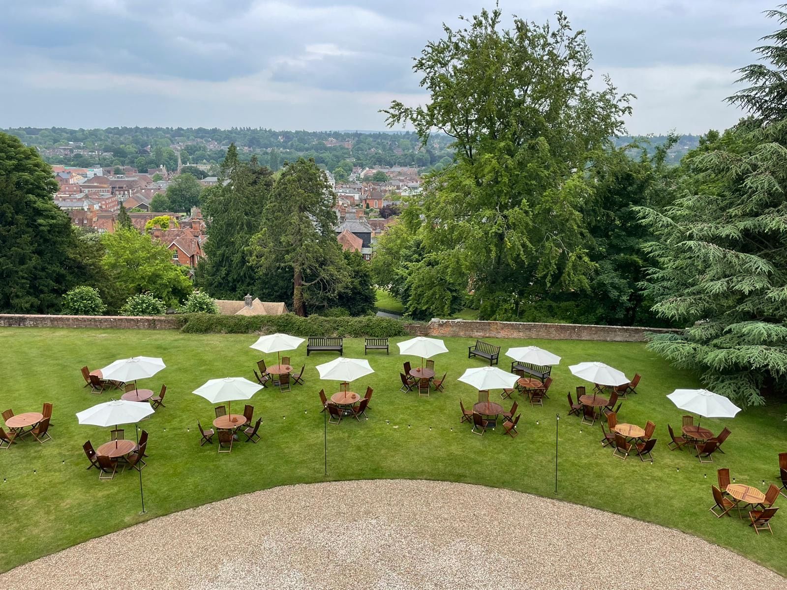 The Great Lawn set with cocktail tables, the town and hills beyond