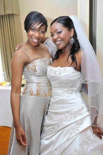 A bride and her bridesmaid together, satin gowns, Tudor Park Hotel