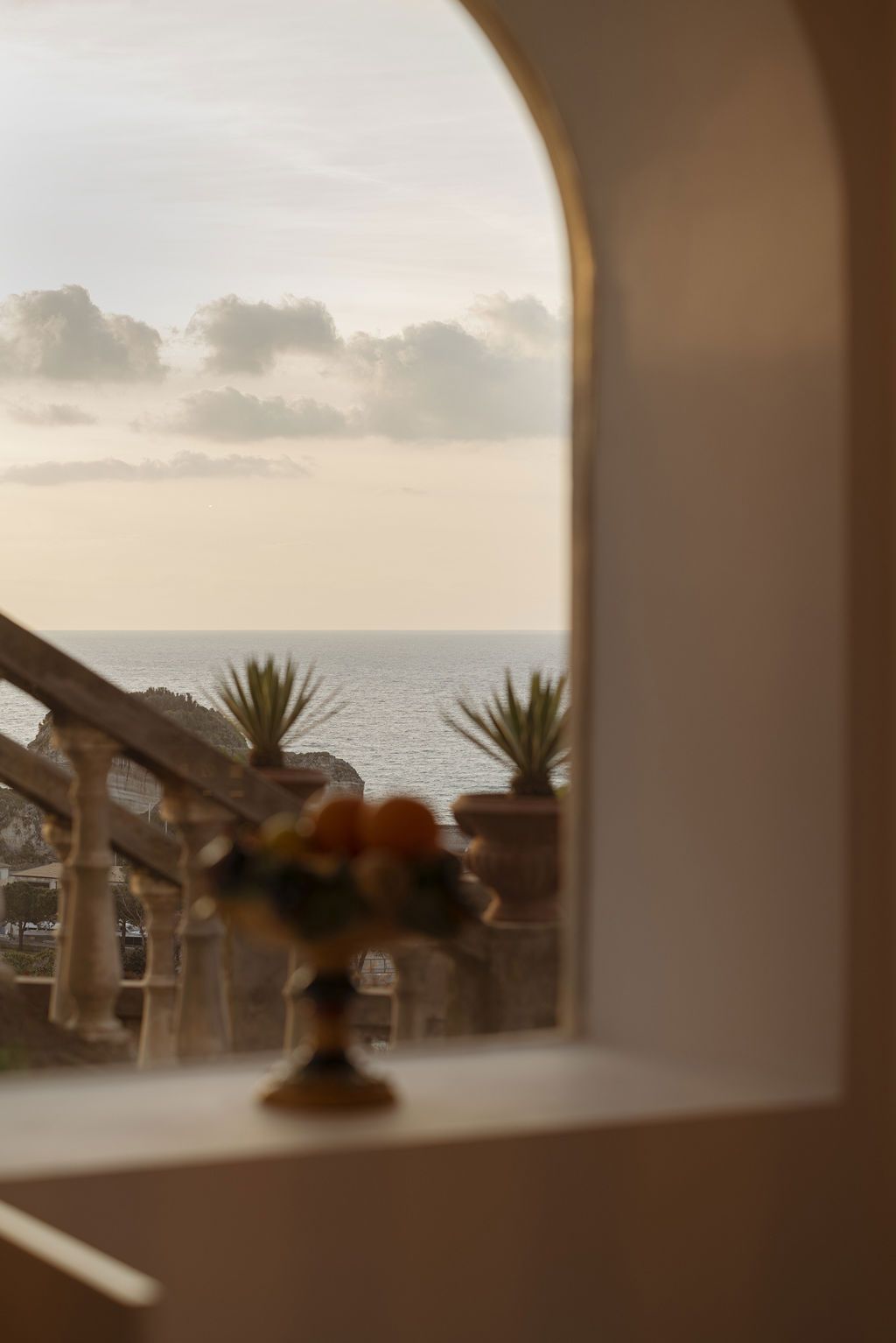 An arched window framing the Tyrrhenian