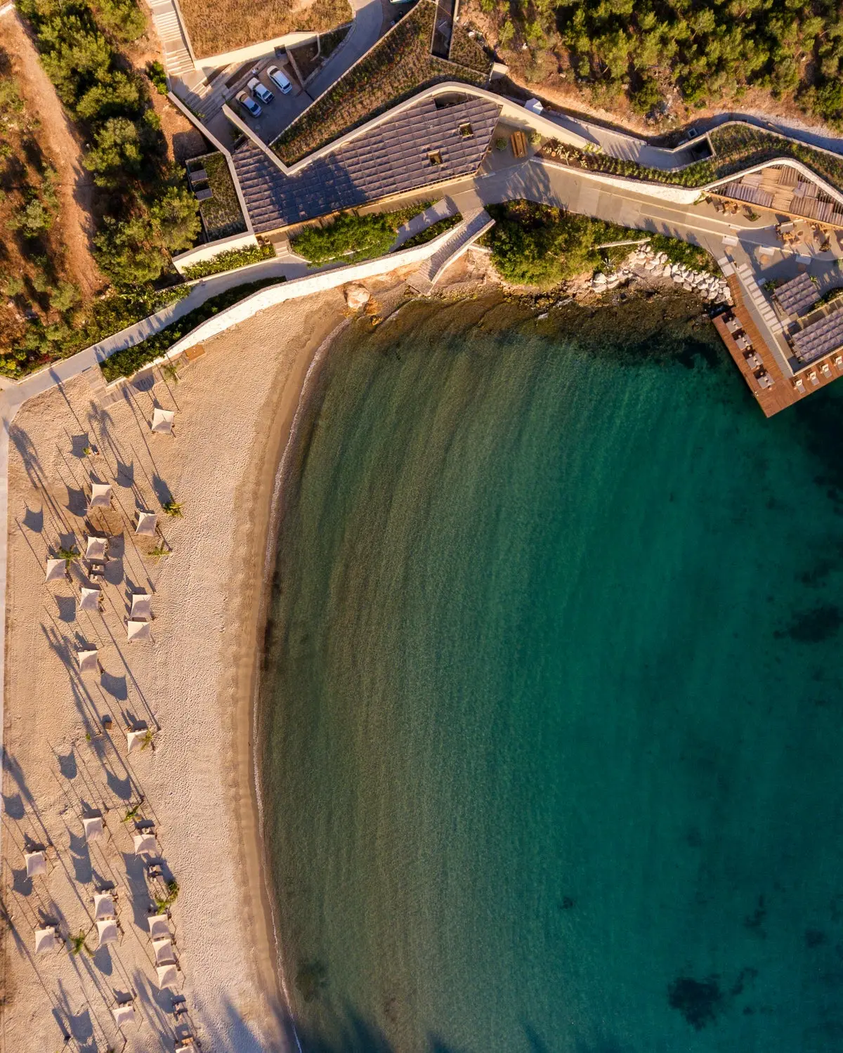 Aerial view of the overwater beach club deck and loungers