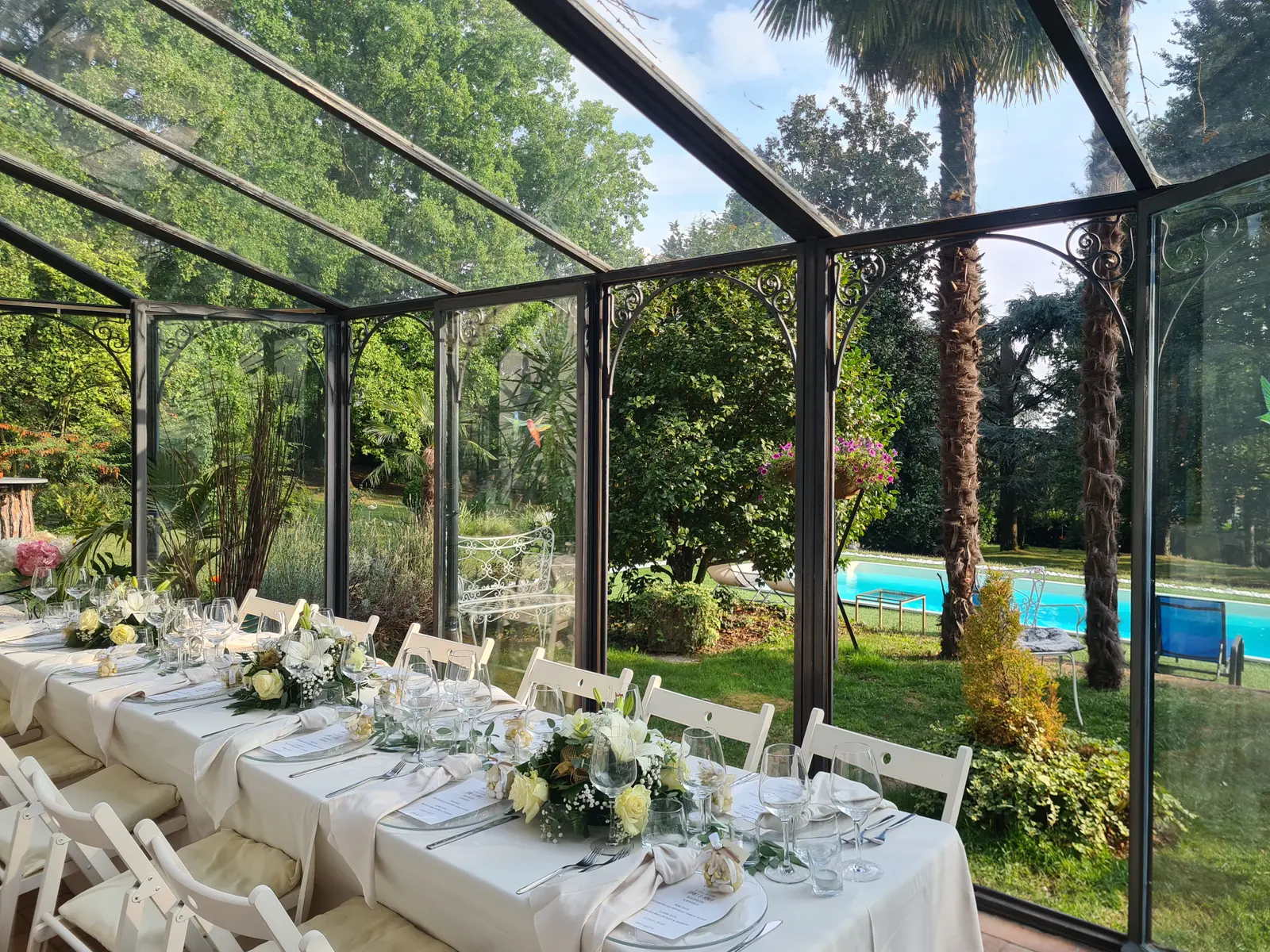 A long banquet table in a glass conservatory
