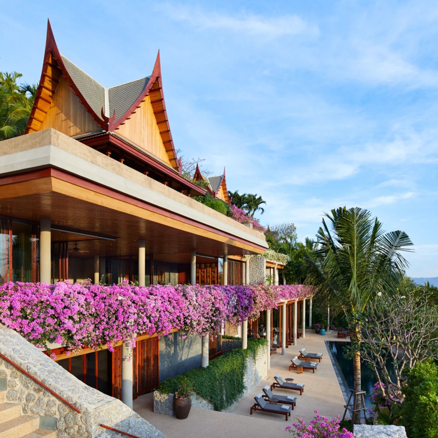An Amanpuri villa's Thai roofline above a terrace of cascading bougainvillea